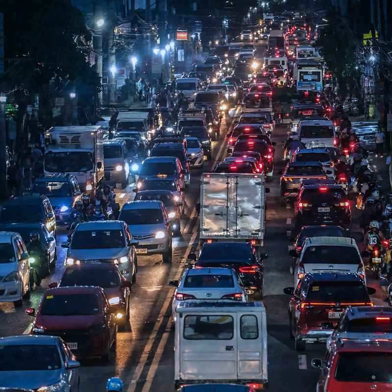 Evening traffic jam of cars, vans, jeepneys and motorcycles on a busy Cebu City avenue