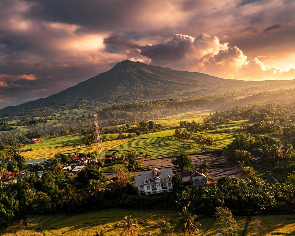 Mount Kanlaon rising above farms and homes in Canlaon City, Negros Oriental