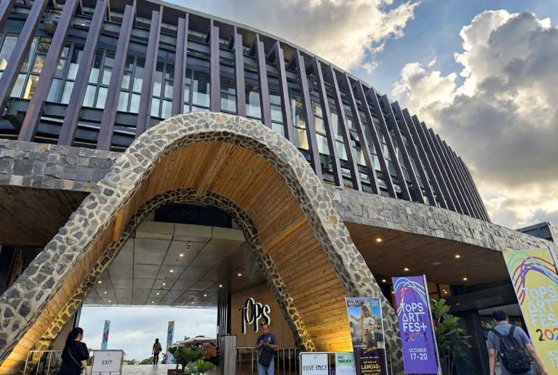 The stone-arched entrance of TOPS in Busay, Cebu City, with TOPS ArtFest banners standing beside the doorway
